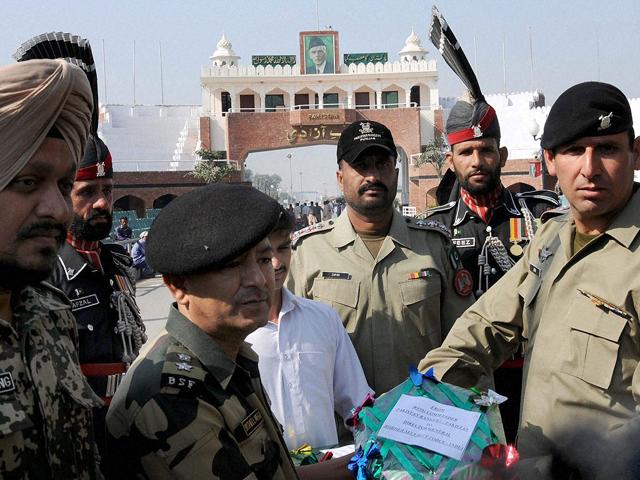 BSF’s officiating commandant Sushil Negi handing over sweets to Superintendent of Pak Rangers on the occasion of Diwali at Attari International Border.
