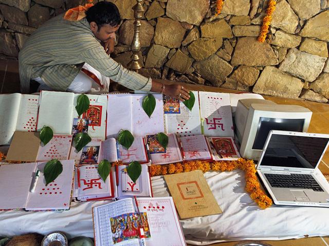 A Hindu priest places leaves on record-keeping books as part of a ritual to worship the Hindu goddess of wealth Lakshmi during the Hindu festival of lights Diwali in the western Indian city of Ahmedabad. The ritual, also known as "Muhurat trading", is considered auspicious by traders and marks the beginning of a new trading year for the Gujarati community.