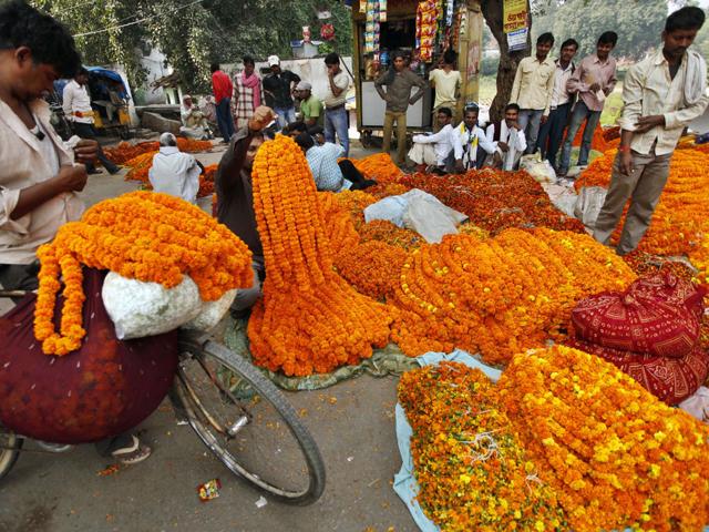 Roadside vendors sell marigold flower garlands on Diwali in Allahabad, India. Diwali, the Hindu festival of lights marks the victory of good over evil and light over darkness.