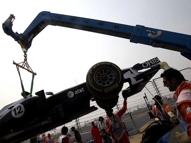 The car of Williams driver Pastor Maldonado of Venezuela is removed from the track after he suffered engine problem his car during a practice session ahead of Sunday's Indian Formula One Grand Prix at the Buddh International Circuit in Noida, 38 kilometers (24 miles) from New Delhi
