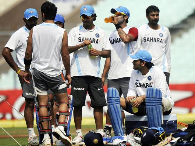 Indian cricket captain Mahendra Singh Dhoni (2R) and teammates take a break during a training session on the eve of the only Twenty20 match against England at the Eden Gardens in Kolkata. (AFP)