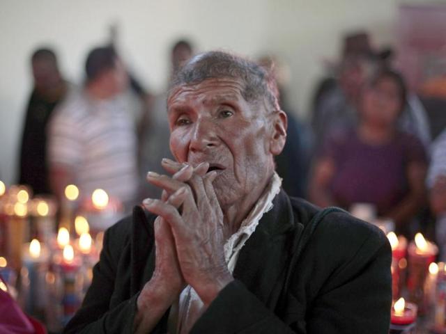 A man prays in the church of San Simon in Iztapa, in the region of Escuintla, 62 km (39 miles) from Guatemala City. For some devotees, San Simon is synonymous with prosperity and happiness, while others associate him with witchcraft, paganism and a protector for drunkards. Since the 19th century, devotees have offered money, liquor or tobacco in exchange for his blessings.
