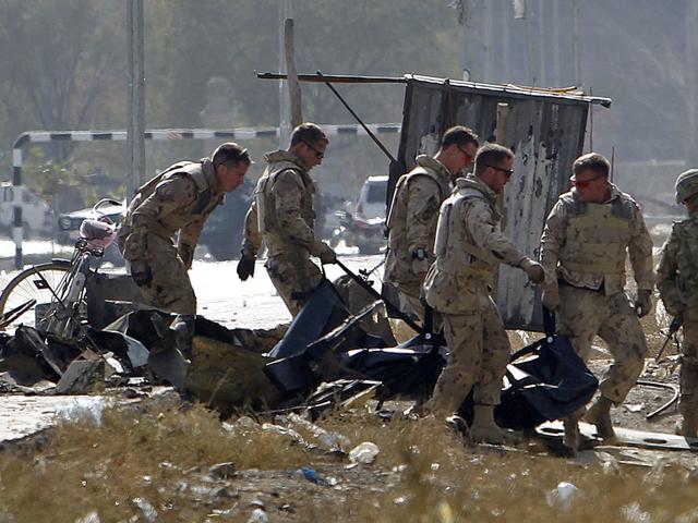 Foreign troops carry a casualty from the site of a suicide attack in Kabul.