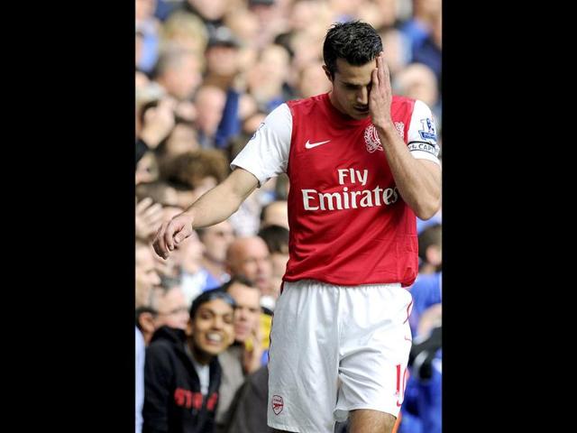Arsenal's Robin van Persie reacts after missing a chance to score during their English Premier League soccer match against Chelsea at the Stamford Bridge Stadium, London. (AP)
