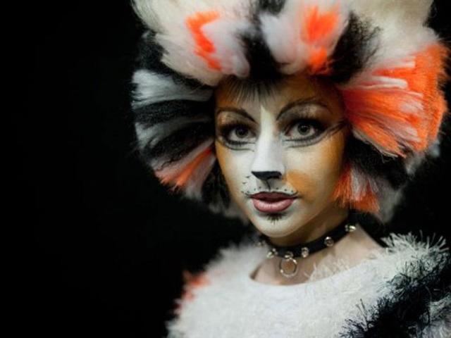 A woman in full costume poses for a photograph before entering the MCM London Comic Con convention at the ExCel centre in east London.
