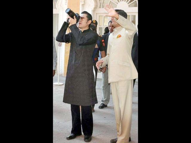 Bhutan's King Jigme Khesar Namgyel Wangchuk takes a photograph at Mehrangarh fort in Jodhpur.