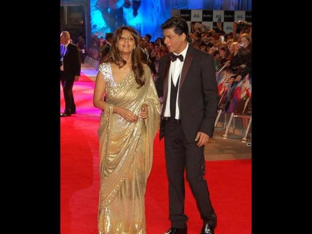 SRK with wife Gauri, who fails to impress in her golden sari.