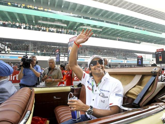 HRT-driver-Narain-Karthikeyan-on-a-vintage-car-during-the-driver-s-parade-of-the-Indian-Formula-One-GP-at-the-Buddh-International-Circuit HRT-driver-Narain-Karthikeyan-on-a-vintage-car-during-the-driver-s-parade-of-the-Indian-Formula-One-GP-at-the-Buddh-International-Circuit