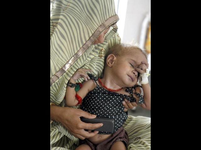 Neetesh is a year old and malnourished. He has come for help to a health centre in Baran district.