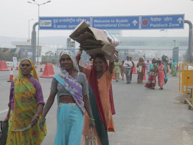 Villagers walk past the entry of International Buddh Circuit a day after Indian Grand Prix event was held at Greater Noida. HT Photo by Mohd Zakir