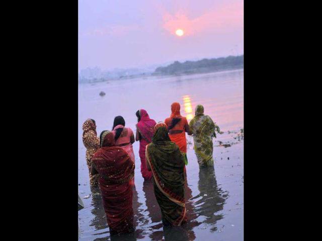 Hindu devotees offer prayers to the sun during the Chhath festival on the banks of the Hussain Sagar lake in Hyderabad . The Chhath festival is observed in India, where homage is paid to the sun and water Gods eights days after Diwali, the festival of lights.