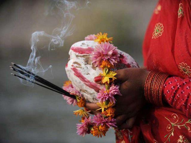 A Nepalese Hindu woman worships the sun as she stands in the Bagmati River during the Chhath festival, which honours the Sun God, in Kathmandu. People pay their respects to both the rising and setting sun during the Chhath festival when people express their thanks and seek blessings from the forces of nature.