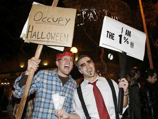 Nathan Harris (L) and Matt Briskie, both from Los Angeles, pose as a Occupy Wall Street protester and a member of the richest one percent respectively, at the West Hollywood Halloween Costume Carnaval in West Hollywood, California. Officials estimate that 400,000 people would attend what is described as one of the world's largest annual Halloween celebrations.