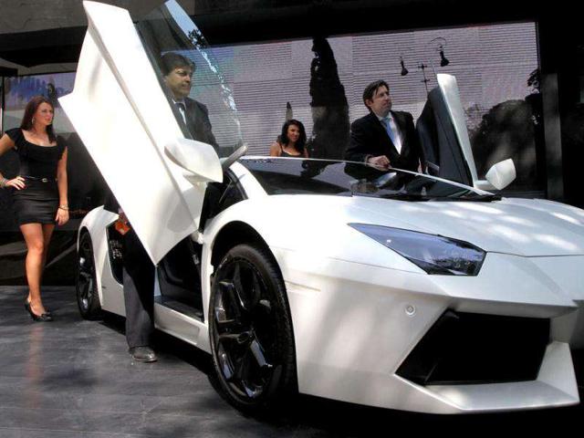 Exclusive Motors Marketing Manager for Asia Pacific James Page (R) and Managing Director Satya Bagla pose with a Lamborghini Aventador LP 700-4 supercar during vehicle's launch event in New Delhi. Lamborghini has unveiled their latest supercar Aventador in India at a whopping price of Rs 3.69 core.
