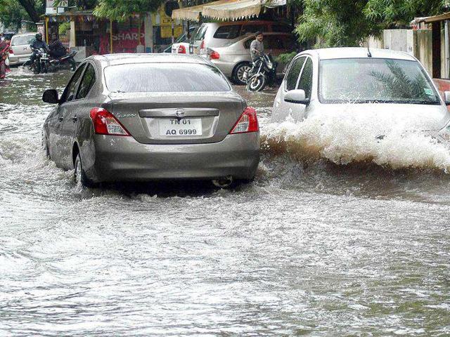 Vehicles passing through a flooded road due to incessant rains in Chennai.