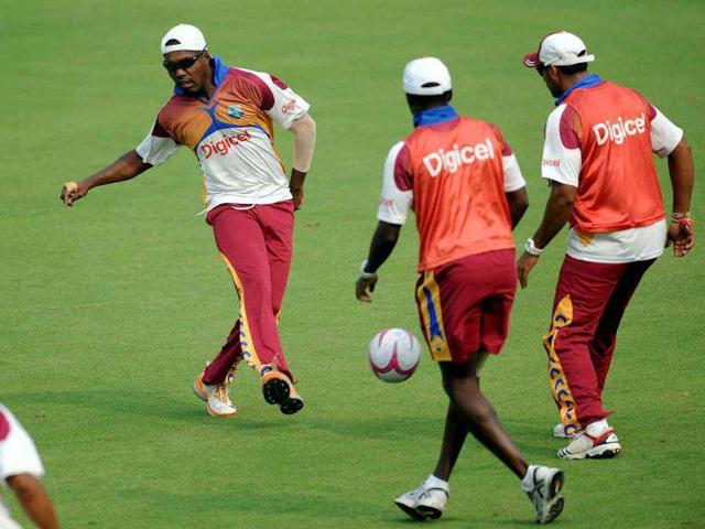 Darren Bravo plays a warm up football match with teammates during a training session at The Ferozeshah Kotla Stadium in New Delhi.