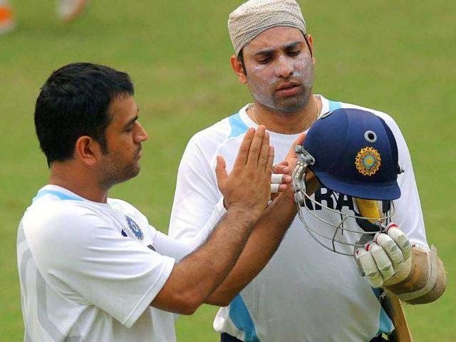Captain Mahendra Singh Dhoni gestures while talking with Venkata Sai Laxman in the nets during a training session at the Feroz Shah Kotla Stadium in New Delhi.