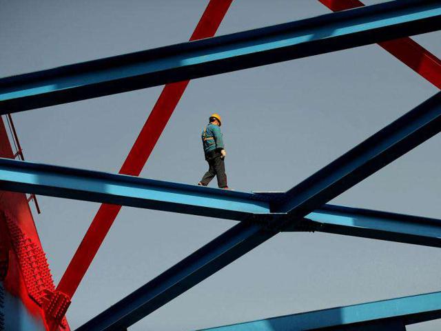 A Chinese worker at the construction site of a new railway link for the hi-speed trains in Hefei, east China's Anhui province. China's cash-strapped railways ministry will receive 200 billion yuan in financial support to help fund projects, the official Xinhua news agency said, as over 80 % of projects currently being built are facing construction slowdowns along the entire line, with many projects facing a one-year delay in completion.
