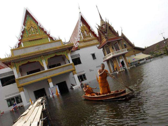 Buddhist monks travel on a boat at a flooded temple in Bangkok. The floods in Thailand began in July and have devastated large parts of the central Chao Phraya river basin, killed nearly 400 people and have disrupted the lives of more than two million.