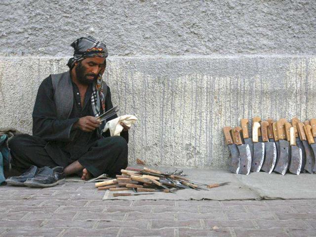 A man cleans knifes and choppers for sale on a sidewalk ahead of the Eid al-Adha festival in Quetta. Muslims around the world celebrate Eid al-Adha, marking the end of the haj, by slaughtering sheep, goats, cows and camels to commemorate Prophet Abraham's willingness to sacrifice his son Ismail on God's command.