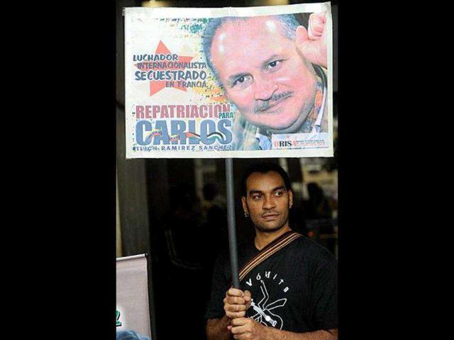A suppoter of Venezuelan "Carlos, the Jackal", holds a sign during a demonstration in front of the Venezuela ombudsman office, in Caracas. Vladimir Ramirez, the brother of Carlos, submitted a demand requesting legal assistance for his brother. (File Photo)