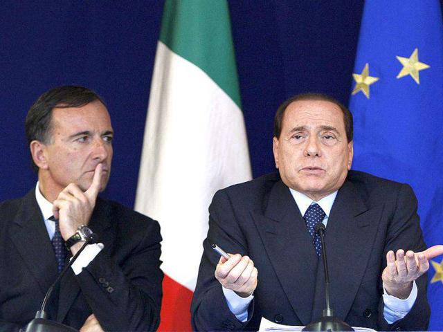 Foreign minister Franco Frattini (L) and Prime Minister Silvio Berlusconi hold a news conference at the end of a European Union leaders summit in Brussels in this October 16, 2008 file photograph. REUTERS/Yves Herman