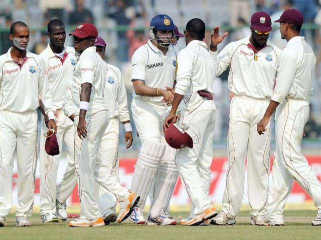 VVS Laxman is congratulated by West Indies cricketers after India beat the West Indies during the fourth day of the first cricket Test match at the Feroz Shah Kotla stadium in New Delhi.