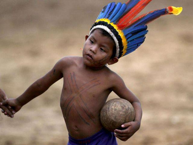 A Paresin Indian youth holds a soccer ball during the Indigenous Games on the island of Porto Real in the city of Porto Nacional, Brazil.