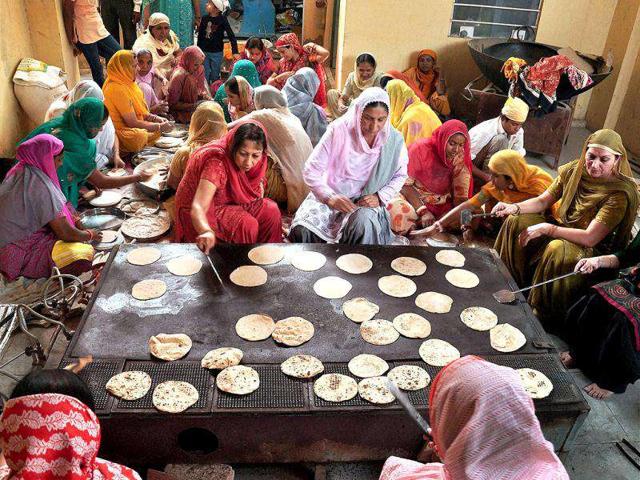 Women preparing "Parsada" at a Gurudwara in Bikaner on the occasion of birth anniversary of Guru Nanak Devji, the founder of the Sikh faith.