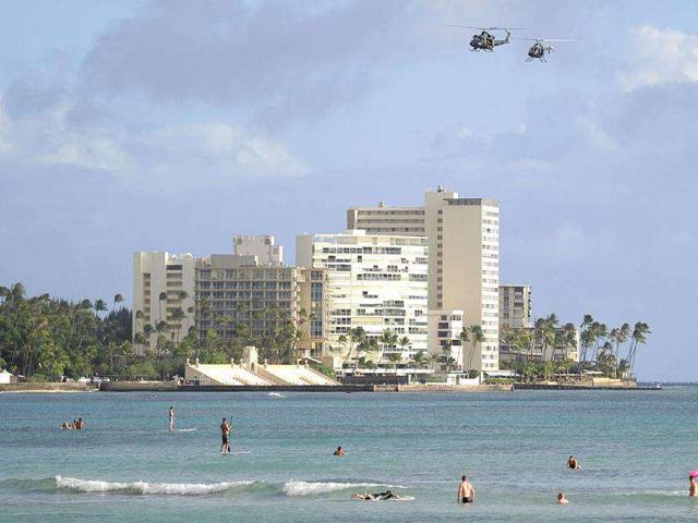 Helicopters patrol Waikiki beach as security is stepped up across the city for the Asia-Pacific Economic Cooperation (APEC) Summit in Honolulu, Hawaii. AFP