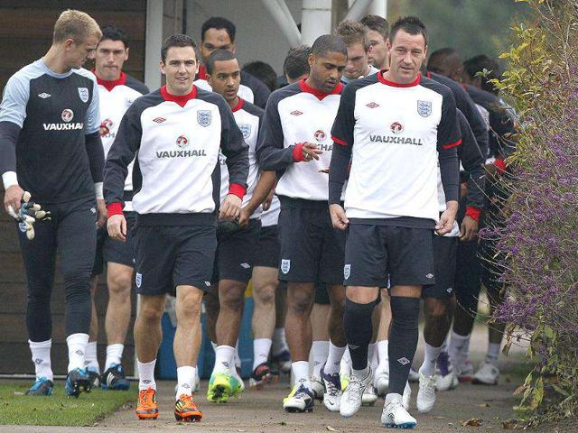 England's soccer player John Terry (R) leads out the team for a training session at London Colney. (Photo: AP)