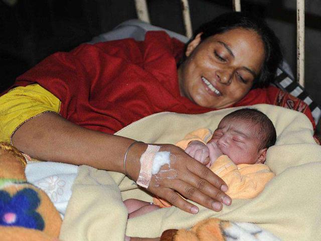 Upkarjeet Kaur rests with her newborn son born on the auspicious "11.11.11" date at a government hospital in Amritsar.
