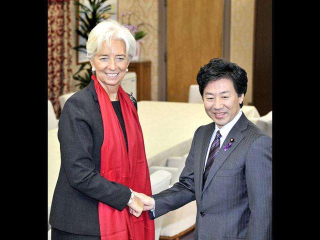 International Monetary Fund managing director Christine Lagarde (L) shakes hands with Japanese finance minister Jun Azumi prior to their talks at Azumi's office in Tokyo. Lagarde said Japan should make reducing its mammoth public debt a priority, during a visit to Tokyo where she met Japanese officials. AFP PHOTO / Yoshikazu Tsuno