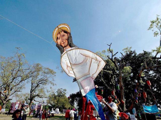 A kite-flyer prepares to fly a kite in the shape of Hindu god Hanuman during a kite-flying festival at the India Gate monument lawns in New Delhi. (AFP Photo/ Manan Vatsyayana)