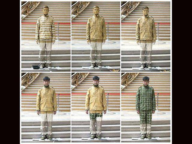 A photo combo shows different stages of Chinese artist Liu Bolin being painted during a happening at the Grand Palais in Paris. AFP Photo Bertrand Langlois