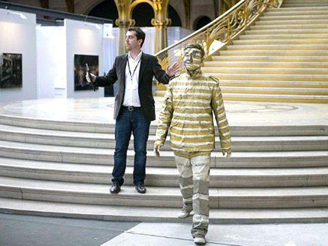 Chinese artist Liu Bolin walks away following a happening at the Grand Palais in Paris. AFP Photo Bertrand Langlois