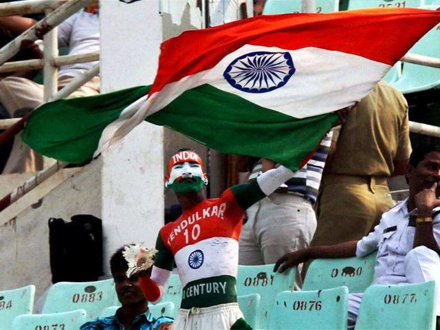 A Sachin Tendulkar fan waves the Tri-colour at Eden Gardens in Kolkata.