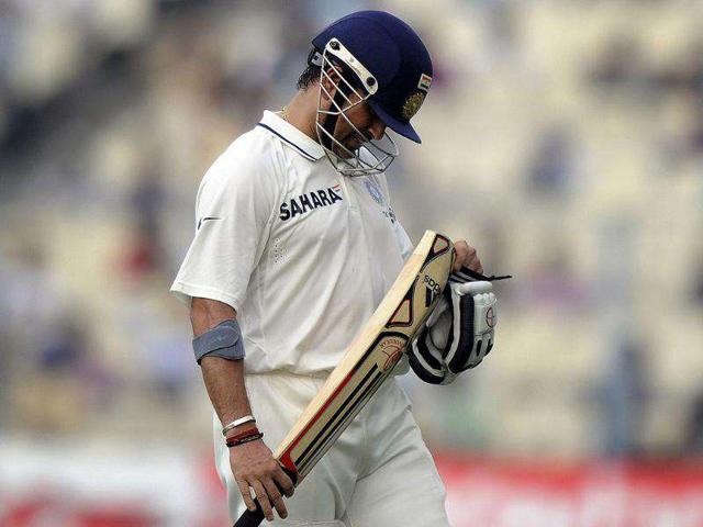 Sachin Tendulkar looks at his bat after losing his wicket during the first day of the second Test cricket match between India and West Indies at The Eden Gardens in Kolkata.