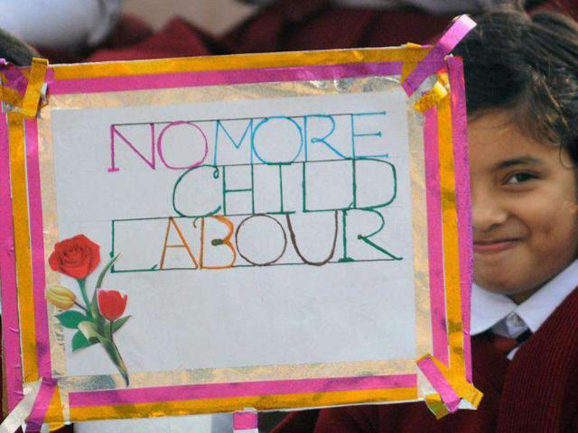 Children hold placards at a function on the occasion of Children's Day in Agartala.