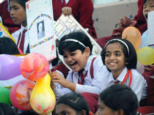 Children hold placards at a function on the occasion of Children's Day in Agartala.