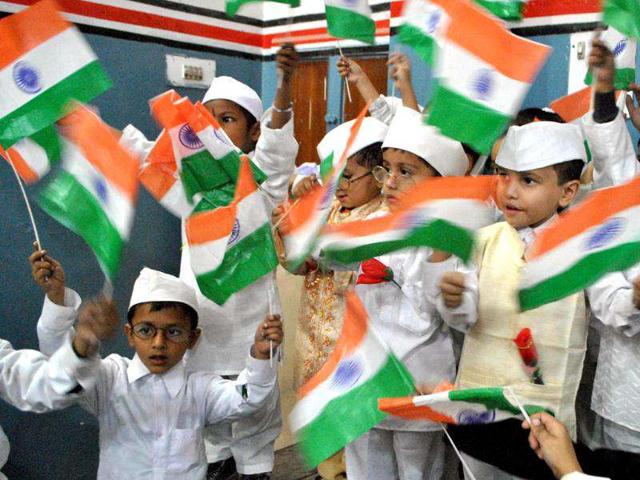 School children hold Indian flags during a tribute-paying ceremony to Pandit Jawaharlal Nehru on his birth anniversary observed as Children's Day in Amritsar.