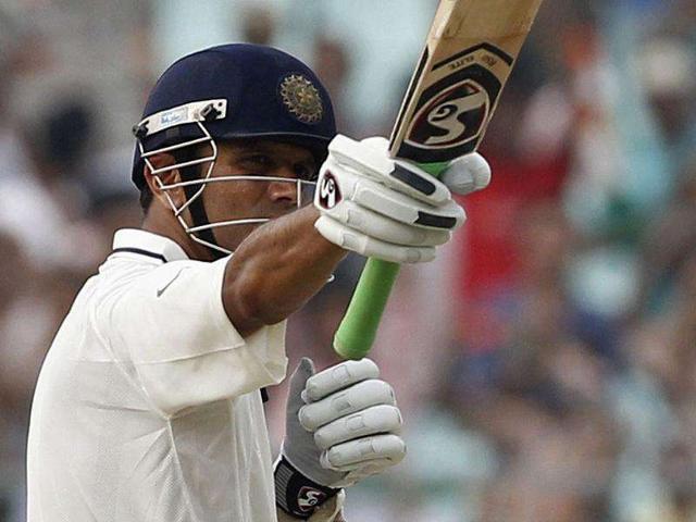 Rahul Dravid raises his bat to celebrate his century on the first day of their second Test cricket match against West Indies in Kolkata.
