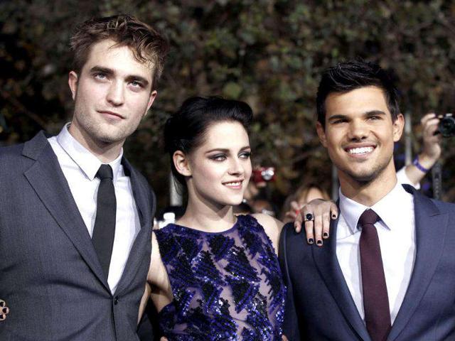 Robert Pattinson (L), Kristen Stewart (C) and Taylor Lautner arrive at the world premiere of The Twilight Saga: Breaking Dawn - Part 1 in Los Angeles. (AP Photo/Matt Sayles)