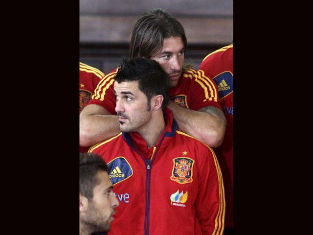David Villa (Front) and Sergio Ramos, members of Spain's national soccer team wait for their team photo shoot with Costa Rica's president during their visit to the presidential palace in San Jose. (AP Photo/Arnulfo Franco)