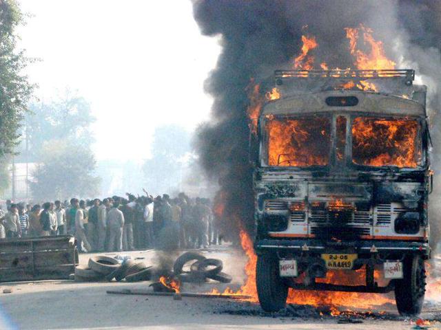 A truck set ablaze by an angry mob after it ran over a man in Mathura.