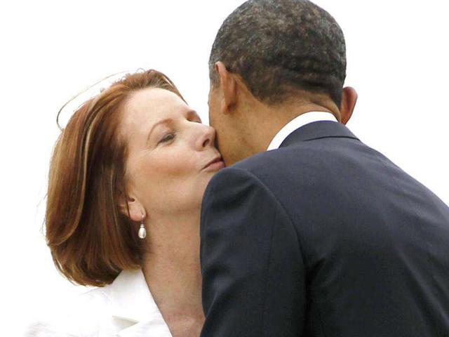 US President Barack Obama is welcomed by Australia's Prime Minister Julia Gillard (L) after arriving in Canberra, Australia.
