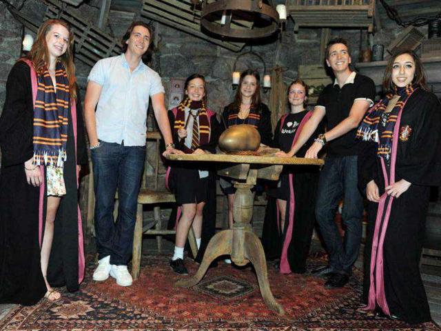 British twins James Phelps (2nd L) and Oliver Phelps (2nd R), who play Fred and George Weasley from the Harry Potter film series, pose with Harry Potter fans during the opening of the Harry Potter exhibition at the Powerhouse museum in Sydney.