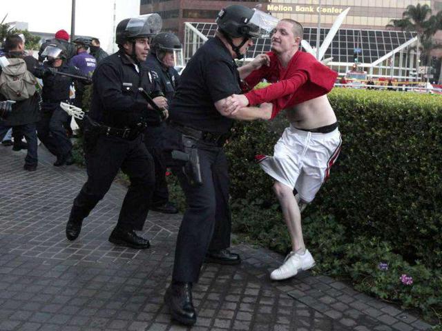 Los Angeles Police Department (LAPD) officers arrest a man at an Occupy LA protest outside a Bank of America office in Los Angeles, California.