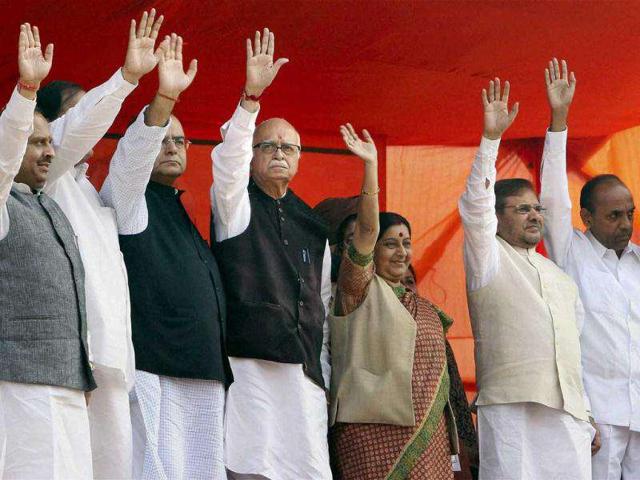 Bharatiya-Janata-Party-BJP-senior-leader-LK-Advani-C-is-presented-with-a-huge-floral-garland-at-a-public-rally-marking-the-end-of-his-thirty-eight-day-long-nationwide-campaign-against-corruption-in-New-Delhi-AP-Photo-Manish-Swarup