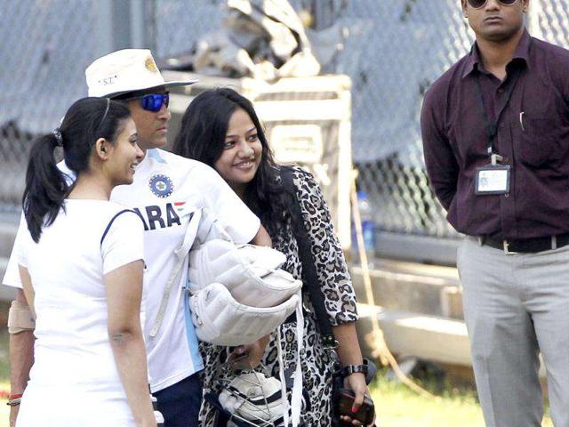 Sachin Tendulkar, second left, poses for photos with fans during a training session ahead of their third Test cricket match against West Indies in Mumbai.